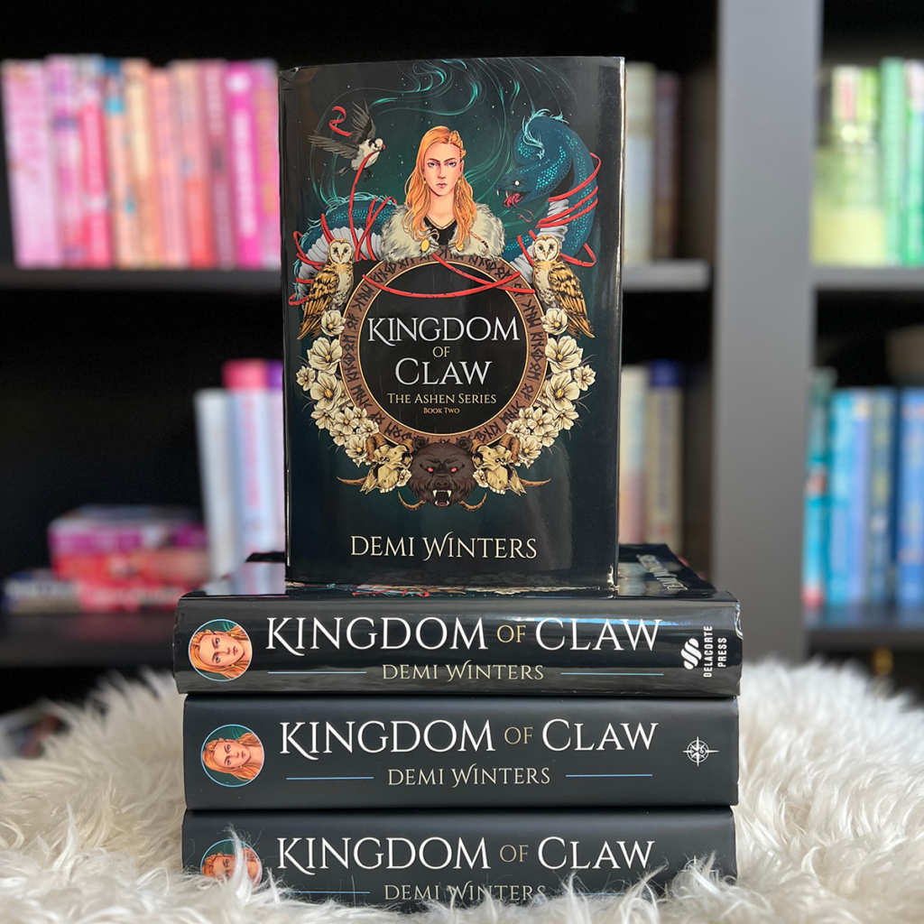 stack of kingdom of claw hardcovers with one book on top facing the camera